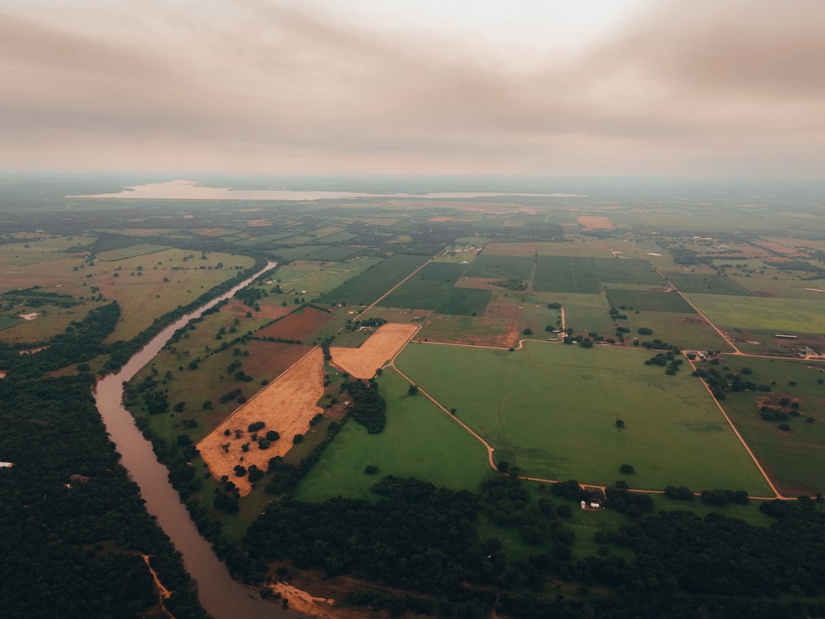 Aerial view of a river winding through green Texas countryside